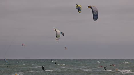 kitesurfers on a windy day at sea in barcelona