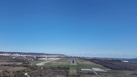 aerial view of airport runway and city