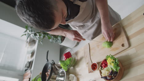 man preparing a healthy meal in a kitchen