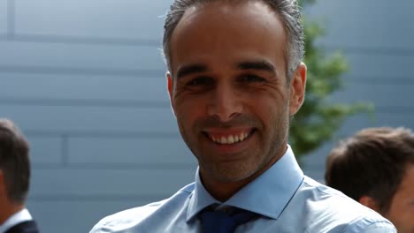 Smiling-businessman-standing-in-office