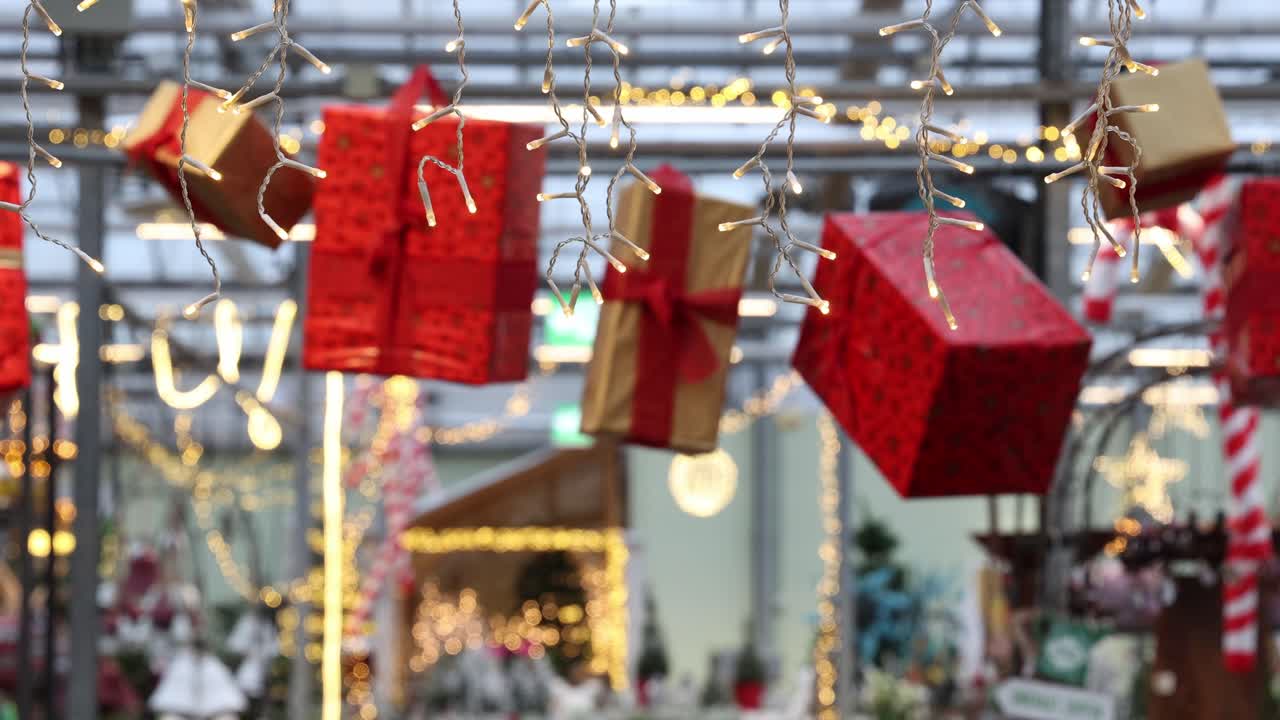 Gifts and fairy lights in a store decorated for Christmas, background establisher