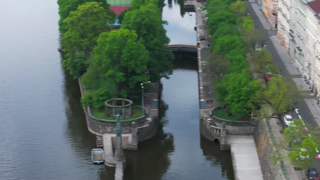 Aerial view of drone fly among buildings and over Vltava river, Czechia