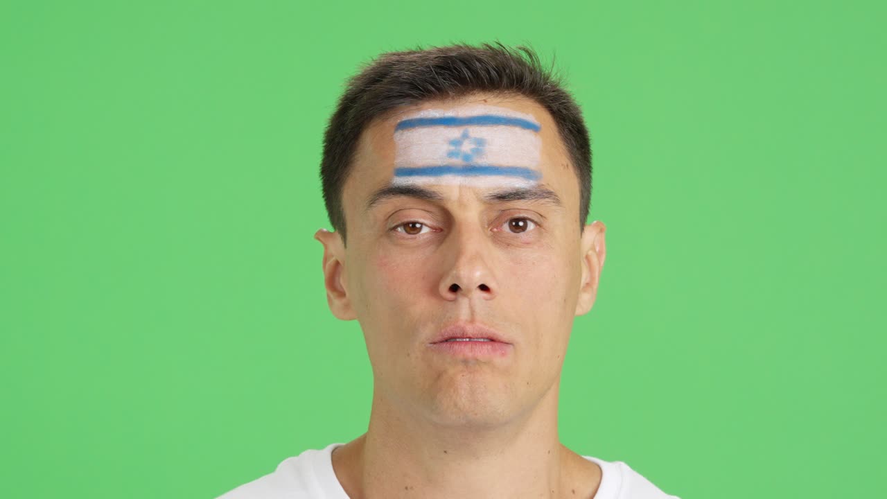 Man with a israeli flag painted on the face smiling