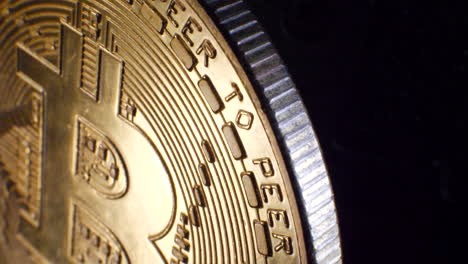 close up reveal shot of a valuable gold shiny digital peer to peer cryptocurrency bitcoin with moving cinematic lighting