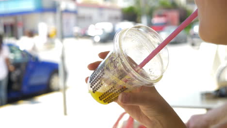 drinking juice or non-alcohol cocktail from plastic cup