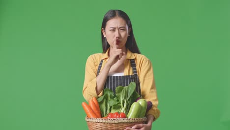 woman holding basket of vegetables