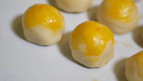 hand put baked chinese pastry on tray, close up-1