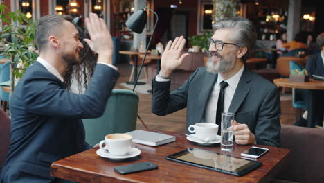 Businessmen having a meeting in a cafe