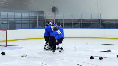 hockey team celebrating victory on ice rink