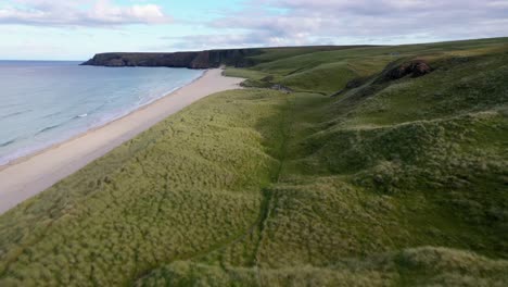 Drone-shot-of-the-"Machair"-or-"seaside-grass-plain"-at-"Traigh-Mhor"-beach-in-Tolsta