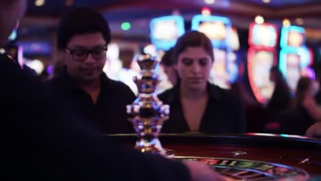 excitement and anticipation unfolding at the roulette table in a vibrant casino atmosphere with engaged players awaiting their fate