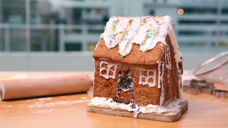 messy gingerbread house on the counter