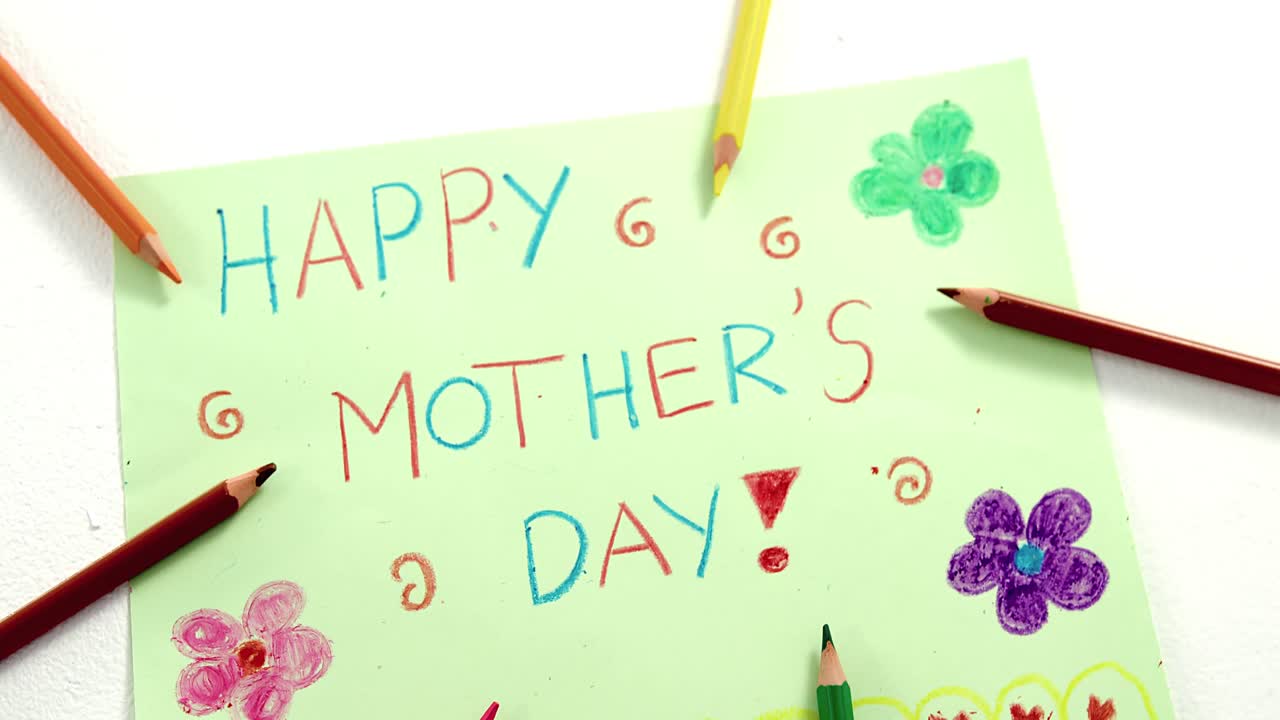 Color pencil arranged around mothers day greetings card