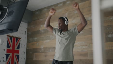 man dancing in a room with headphones on