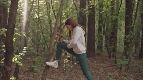 woman stretching in forest