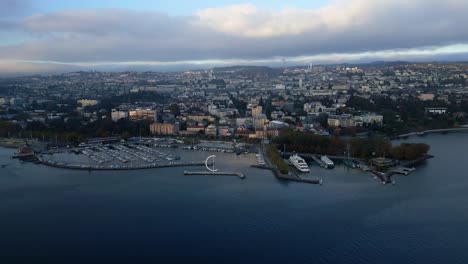pan drone shot of eole sculpture and ouchy port at sunset in lausanne switzerland