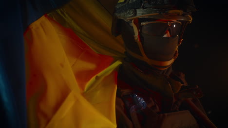 ukrainian soldier with flag in a war zone