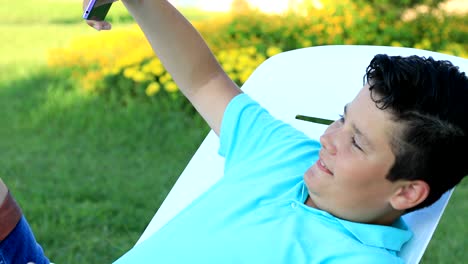 smiling young boy making selfie photo