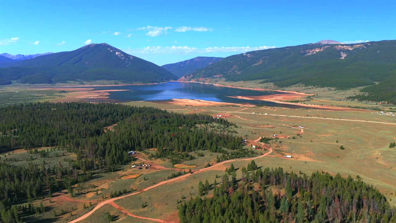 Taylor Park Reservoir Marina Dam, basso livello del lago, drone aereo, Almont Colorado, dal campeggio Lakeview Campground, Contea di Gunnison, mattina estiva soleggiata, cieli blu, Park Cone, Catena del Sawatch, panoramica ascendente in avanti