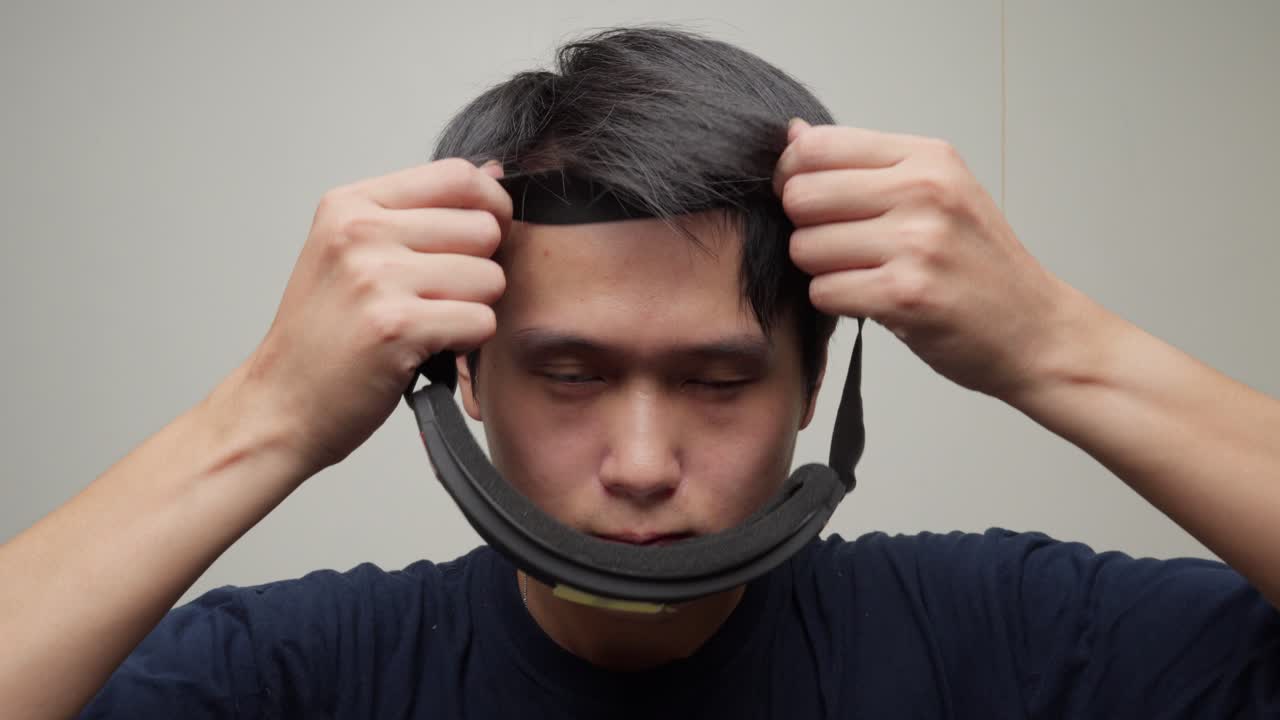 중국인 남자의 초상화는 무지개 거울 렌즈와 함께 사이클링 고글을 착용합니다.