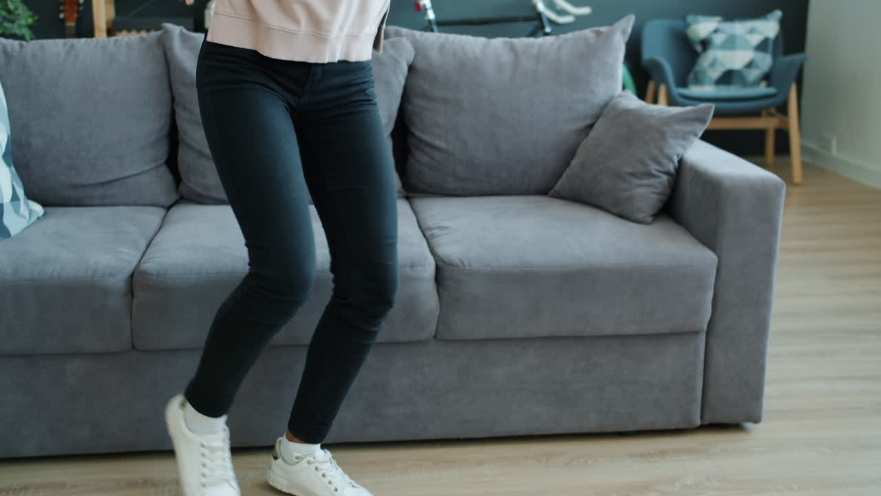 Young Woman Dancing to Music at Home