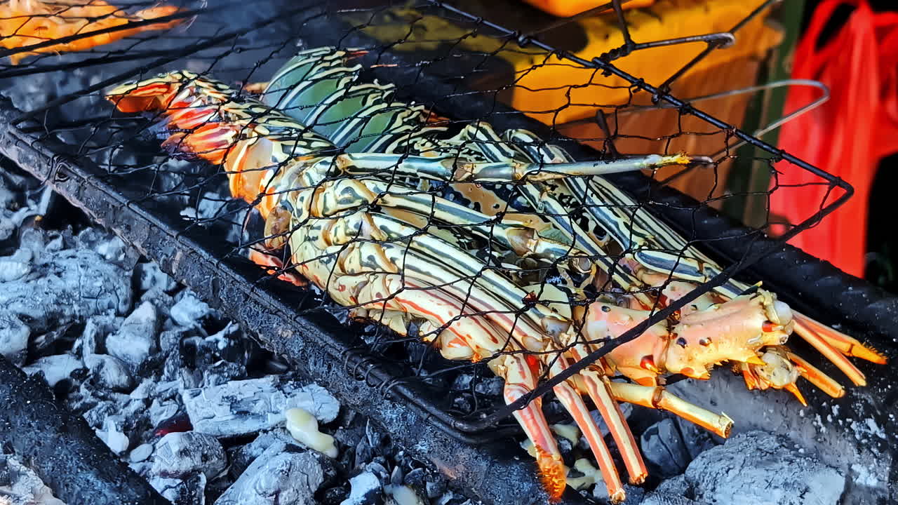 Fresh lobster is grilled over hot charcoal by a vendor at Kedonganan Fish Market, Bali’s famous seafood culinary destination