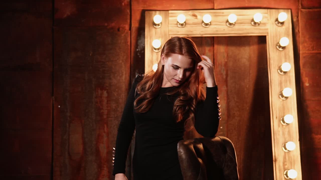 mujer con un vestido negro en un escenario de estudio