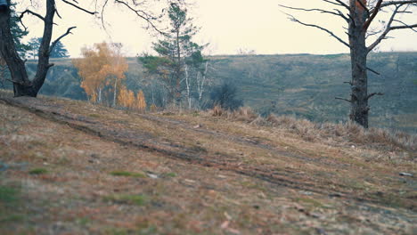 male cyclist skidding riding a mountain bike down the road in the countryside