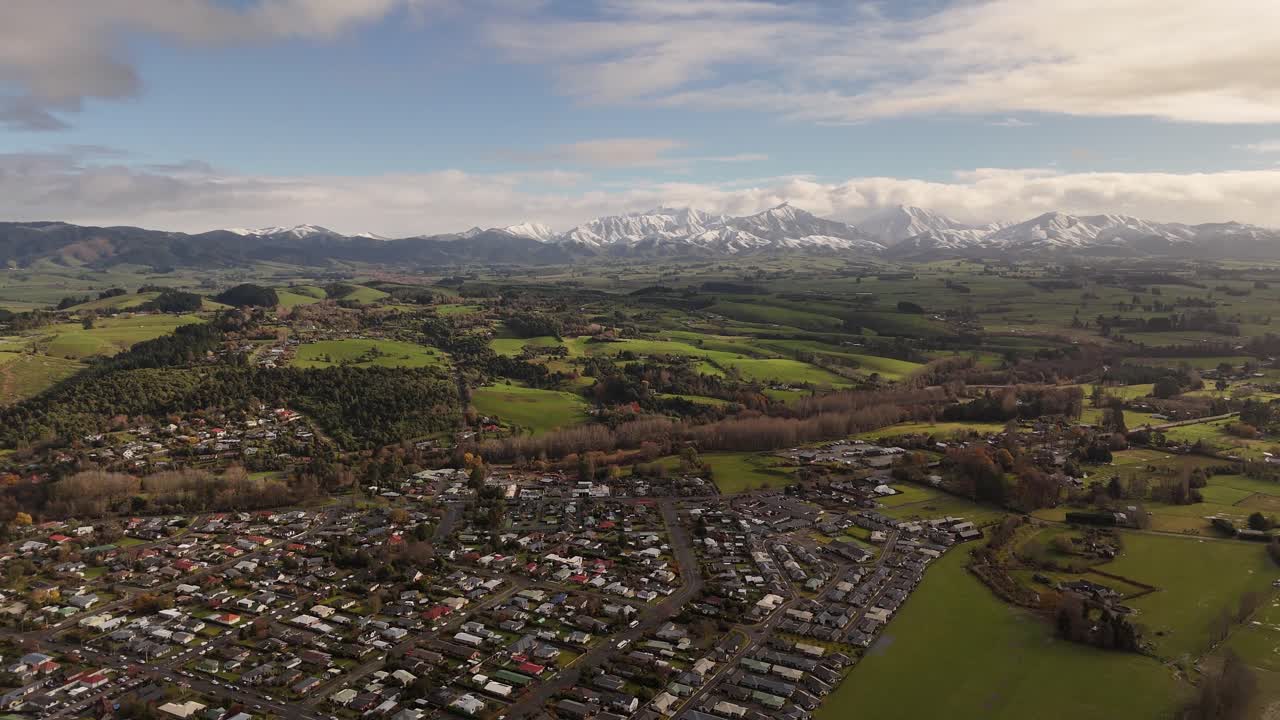 Aerial View of Town with Mountains and Snow