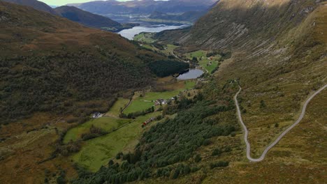 Aerial-over-the-rugged-hills-near-Vanylven-Municipality-leading-to-Sylte-in-the-distance,-Norway