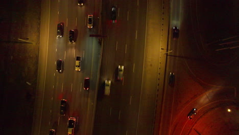 aerial view of top down shot of cars driving down interstate at night in denver, colorado