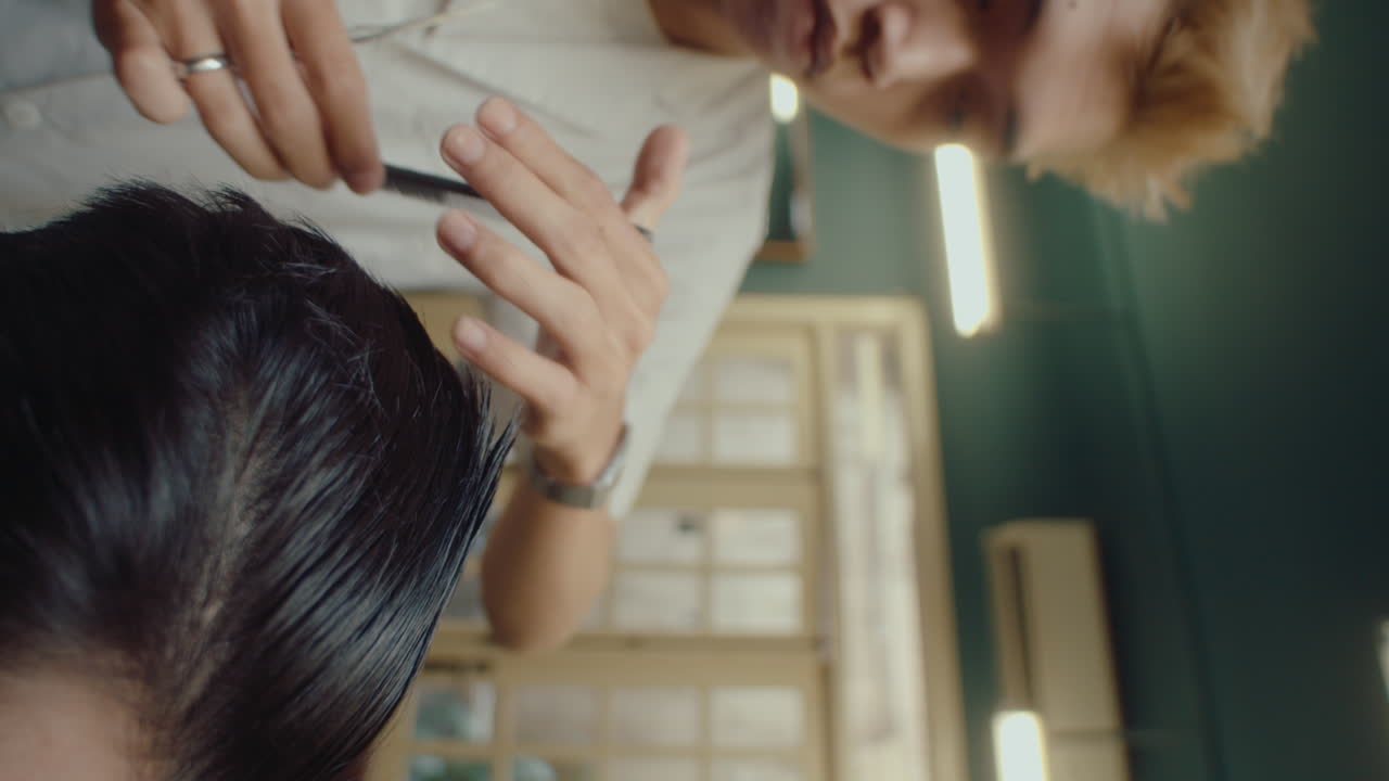 Male Barber Trimming Hair with Shears and Comb