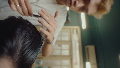 male barber trimming hair with shears and comb