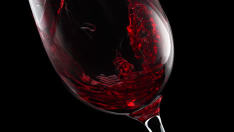 red wine pouring and swirling at the bottom of a crystal glass in slow motion