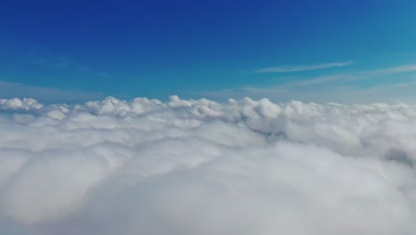 blue sky and white clouds background. stunning footage above clouds with blue sky. travelling by air background. real time footage. aerial view.