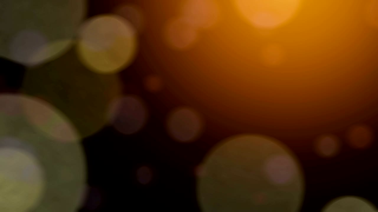 4K abstract bokeh golden light on black background