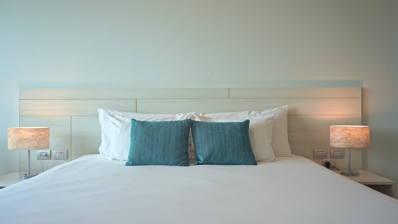 Comfortable King Size Bed and Pillows in Contemporary Hotel Room. Left Pan