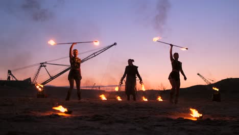 fire show. a group of professional artists performs a variety of fire facilities. boys and girls performed dances with fire in the night on the street in the park.