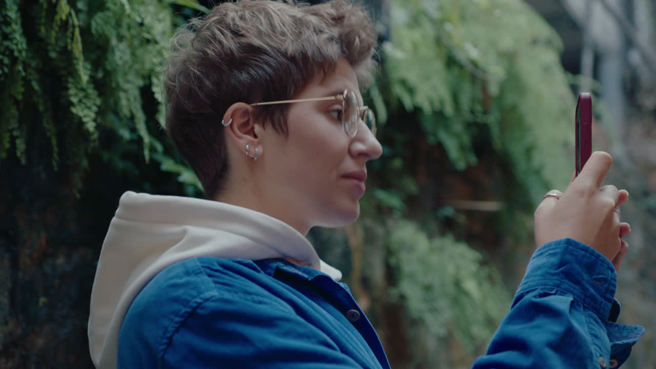 Woman Taking Pictures of Street in Old Town with Smartphone