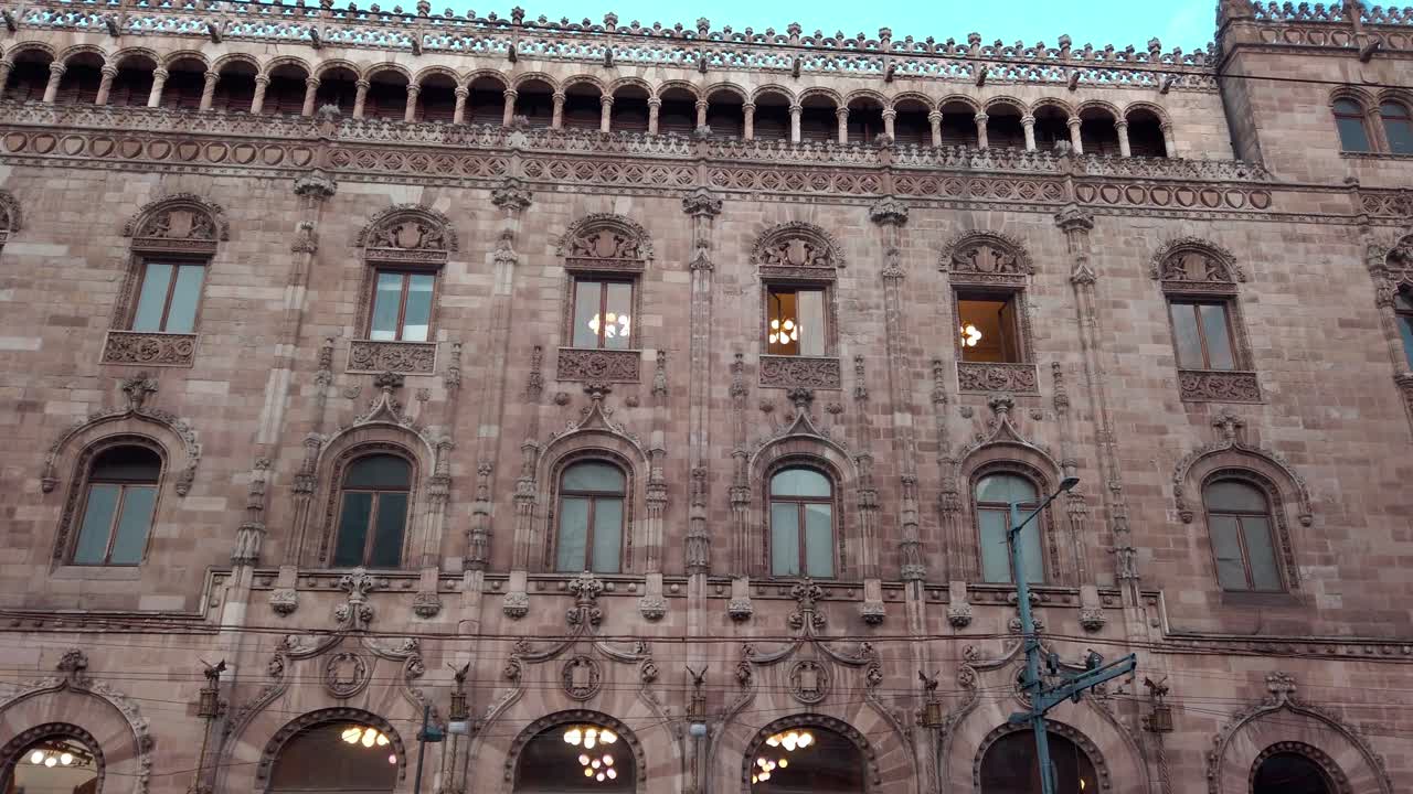 Pan shot of old building wall during the day in a mexican city, wide shot