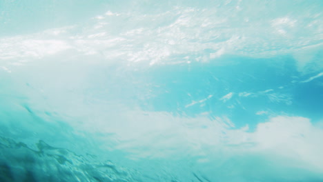 rearview of large barrel rising and crashing into vortex, underwater