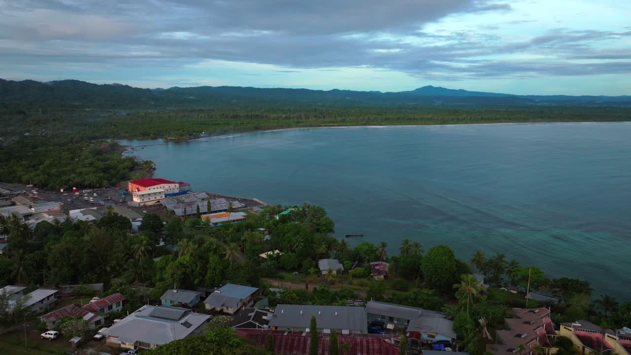 Early morning Sundaun Market Boram Rd Wewak Hill Cape Wom peninsula morning summer dry season Wewak costal town aerial drone Papua New Guinea PNG Dogreto Bay panoramic ocean view forward pan up motion