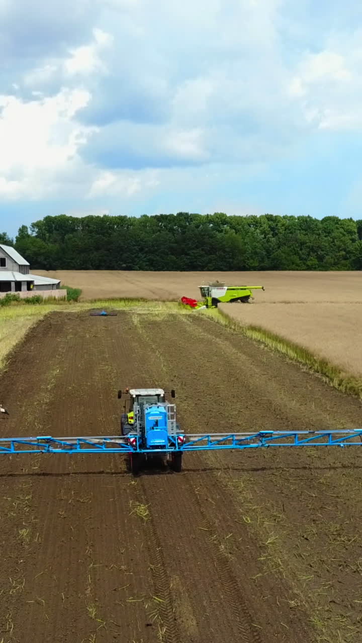 Self-Propelled Sprayer On Farm. Self-propelled sprayer irrigating crops on Vertical video