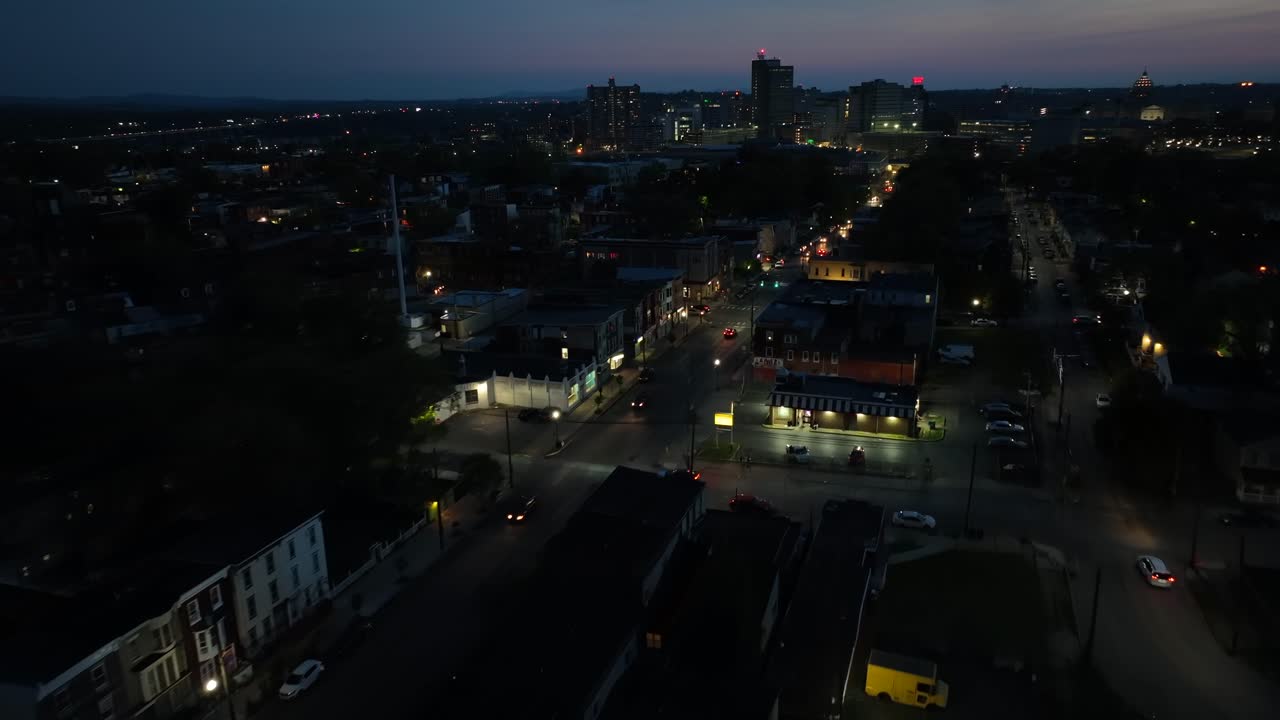 Aerial Night View of a City with Illuminated Streets and Buildings