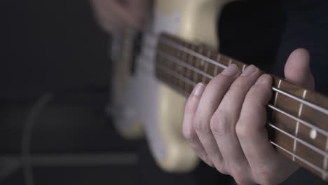 musician plays solo on white bass guitar with pitch shift