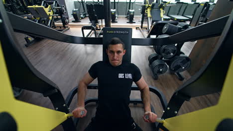 man doing chest press in a gym
