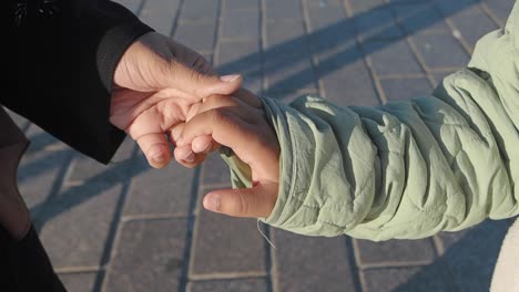 mother and child holding hands