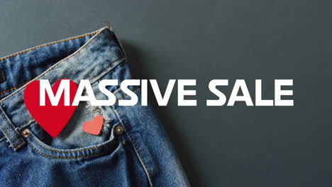 animation of massive sale text over denim trousers background