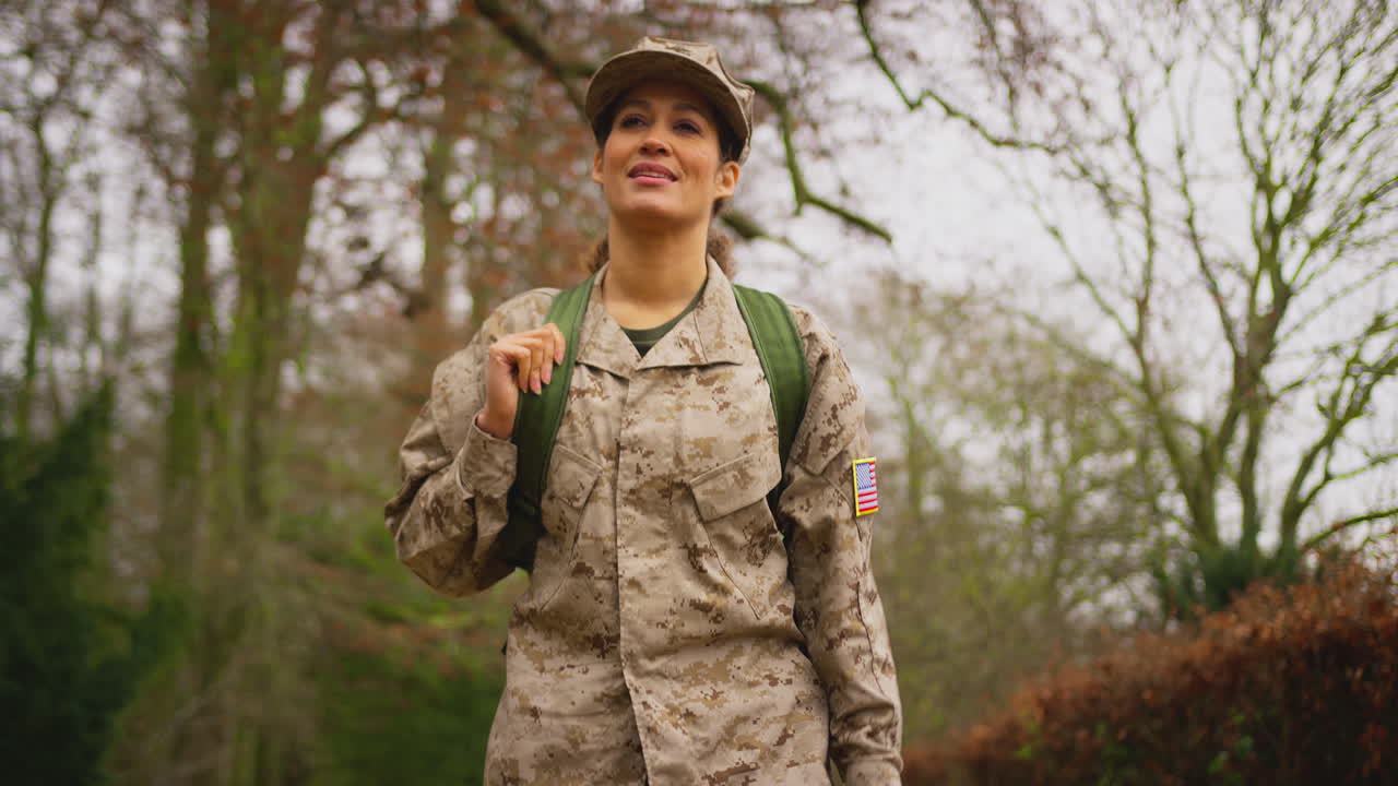 American Female Soldier In Uniform Carrying Kitbag Returning Home On Leave