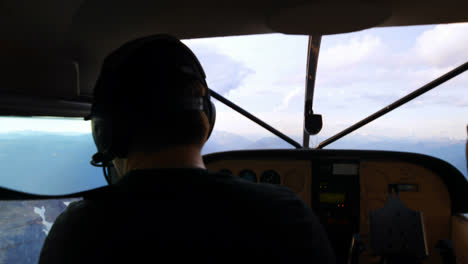 piloto volando un avión sobre una montaña cubierta de nieve 4k